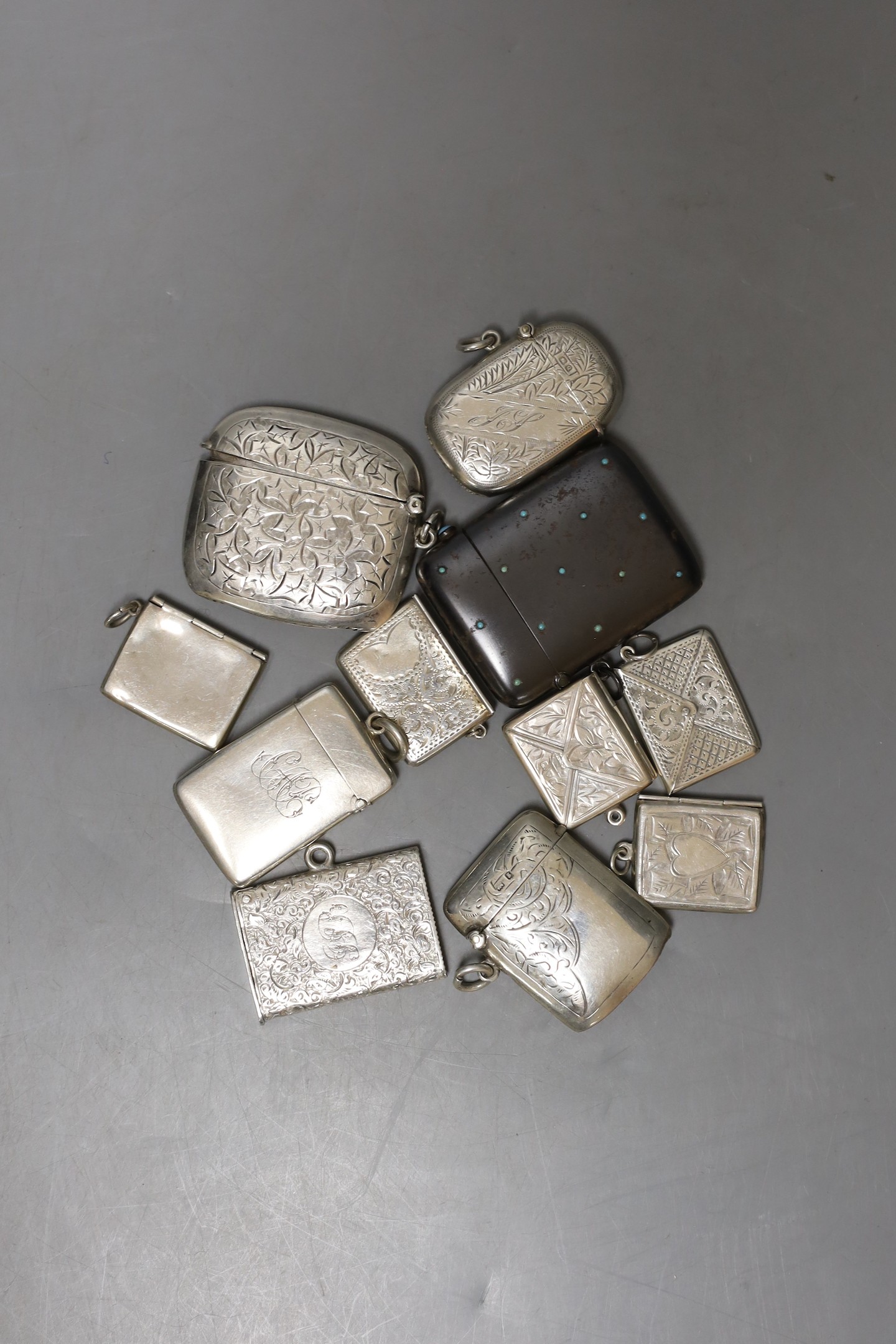 A small collection of assorted mainly early 20th century silver or metal vesta cases and silver stamp cases, largest 51mm.